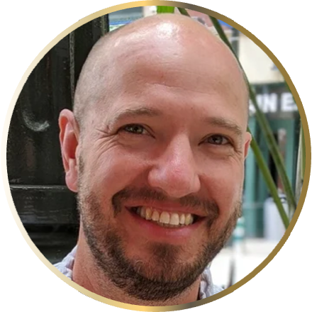 A close-up of a person, Aaron Burch, inside a gold ring