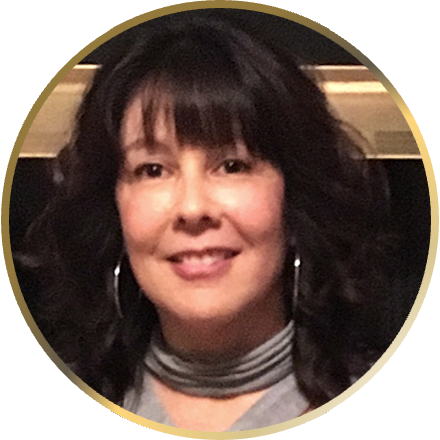 A close-up of a person, Deborah Jackson Taffa, inside a gold ring