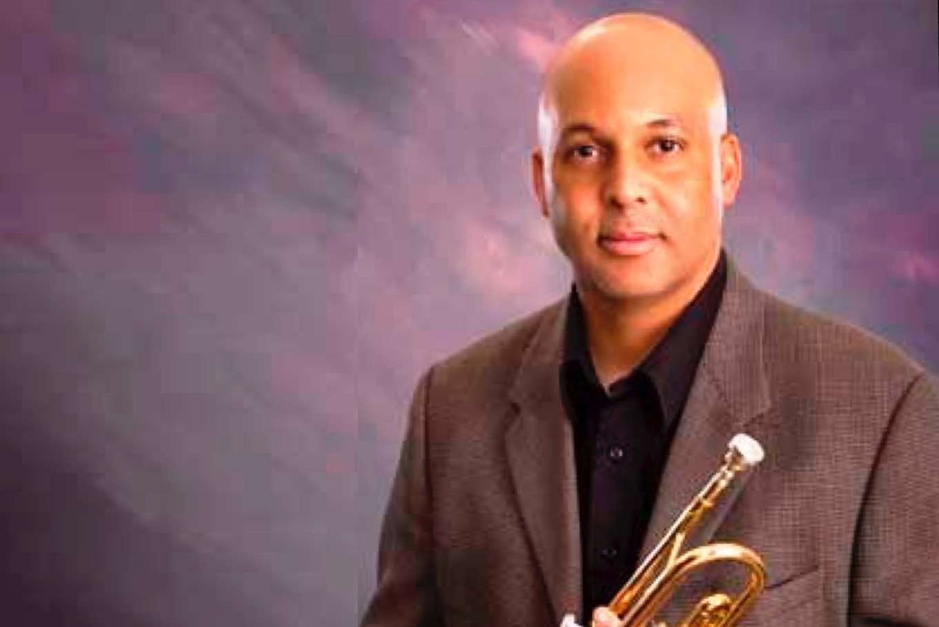 Grossmont College Music Department Chair, Derek Cannon holding his trumpet